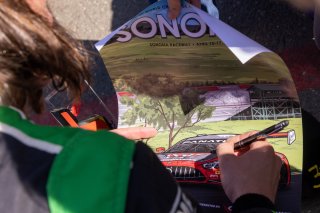 signing a poster, #1 Lamborghini Huracan GT3 of Jordan Pepper and Andrea Calderelli, K-Pax Racing, GT World Challenge America, Pro, SRO America, Sonoma Raceway, Sonoma, CA, April  2022.
 | RegisLefebure/SRO